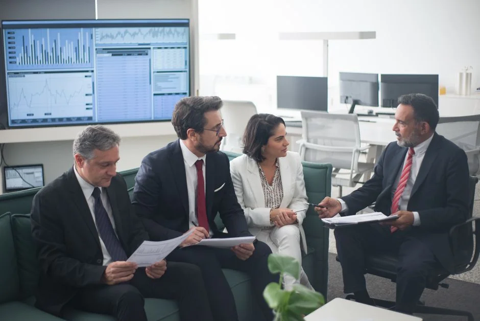 Hands discussing marketing strategy with charts in an office setting.
